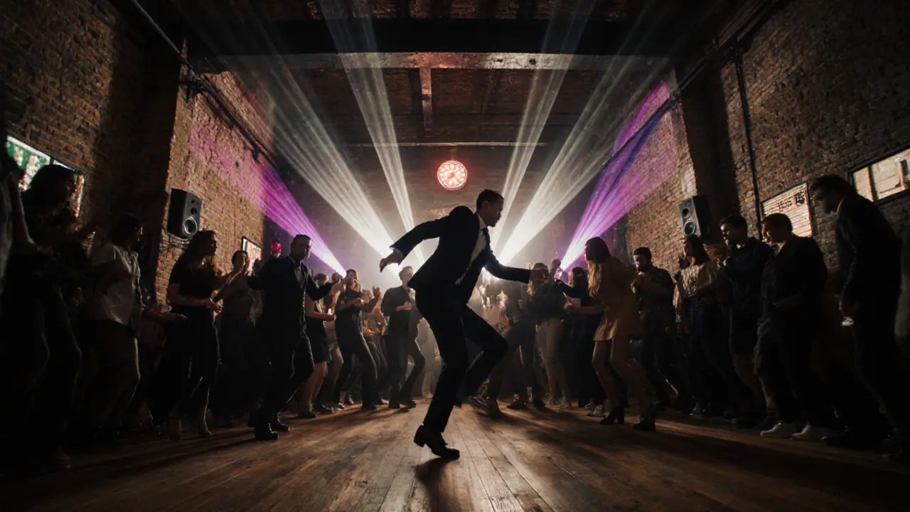 Crowd dancing under colorful projections in a vast industrial club with exposed brick walls